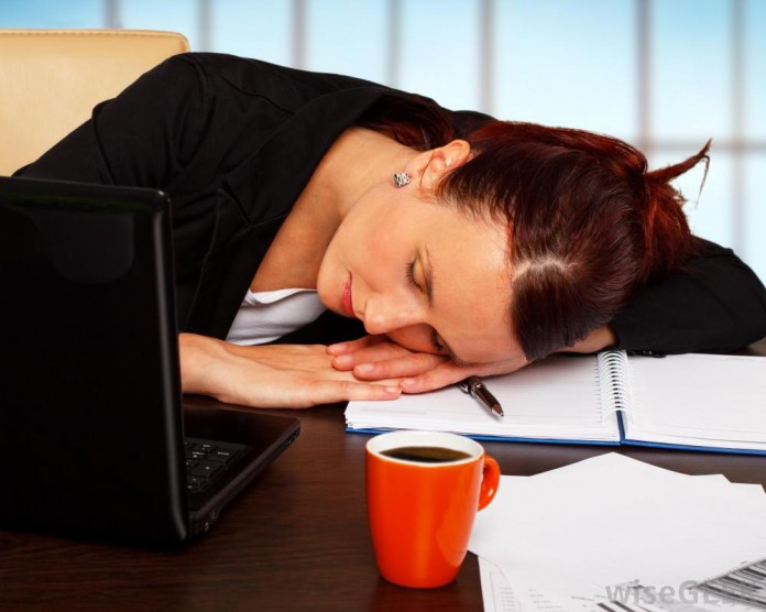 woman-with-red-hair-in-suit-asleep-at-desk Desk Job Ailments