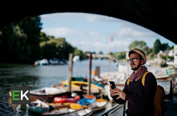 Tourist taking picture alongside a deck 